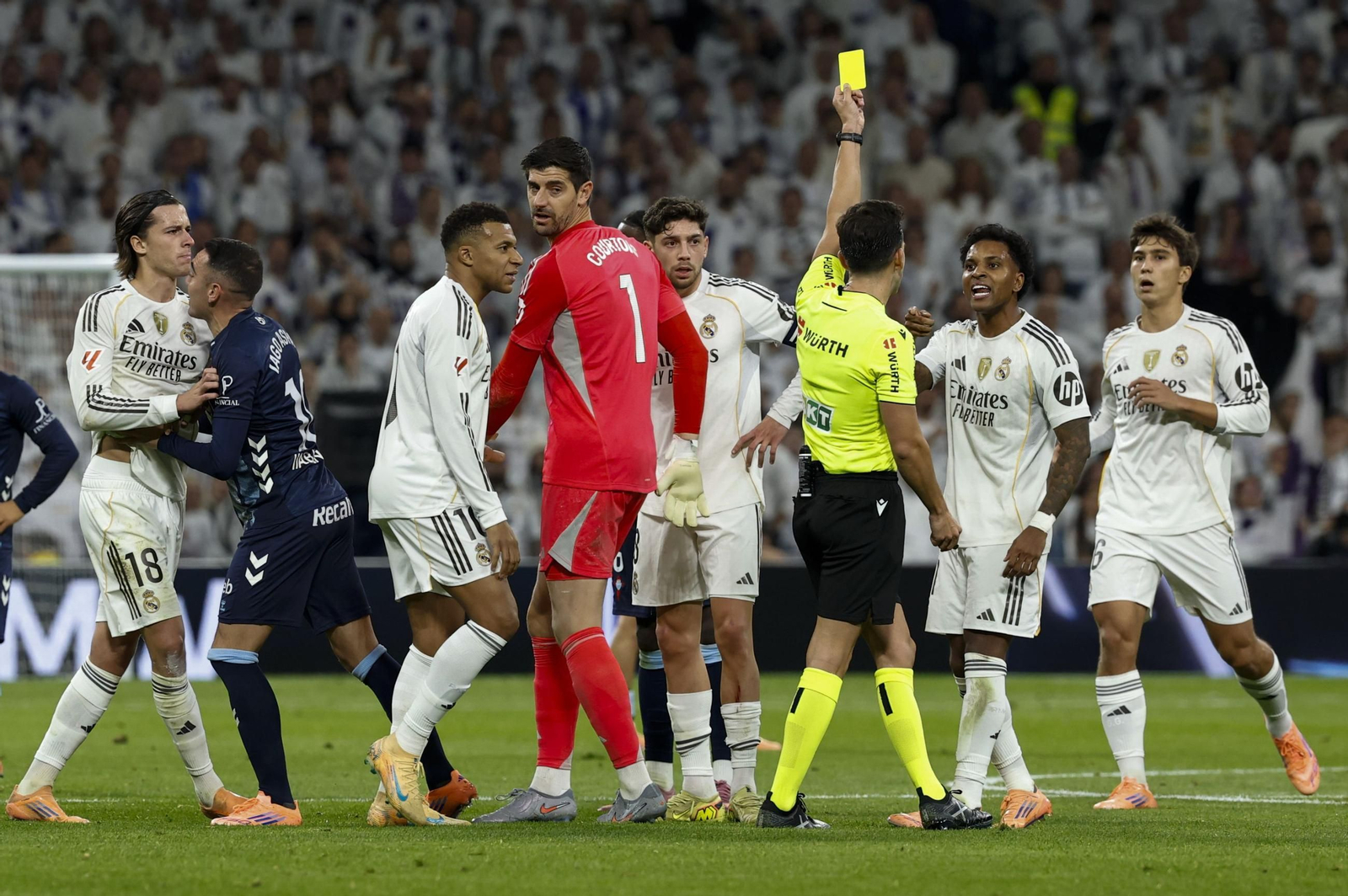 Alejandro Quintero González le muestra la tarjeta amarilla a Rodrygo por sus protestas tras expulsar a Carreras.
