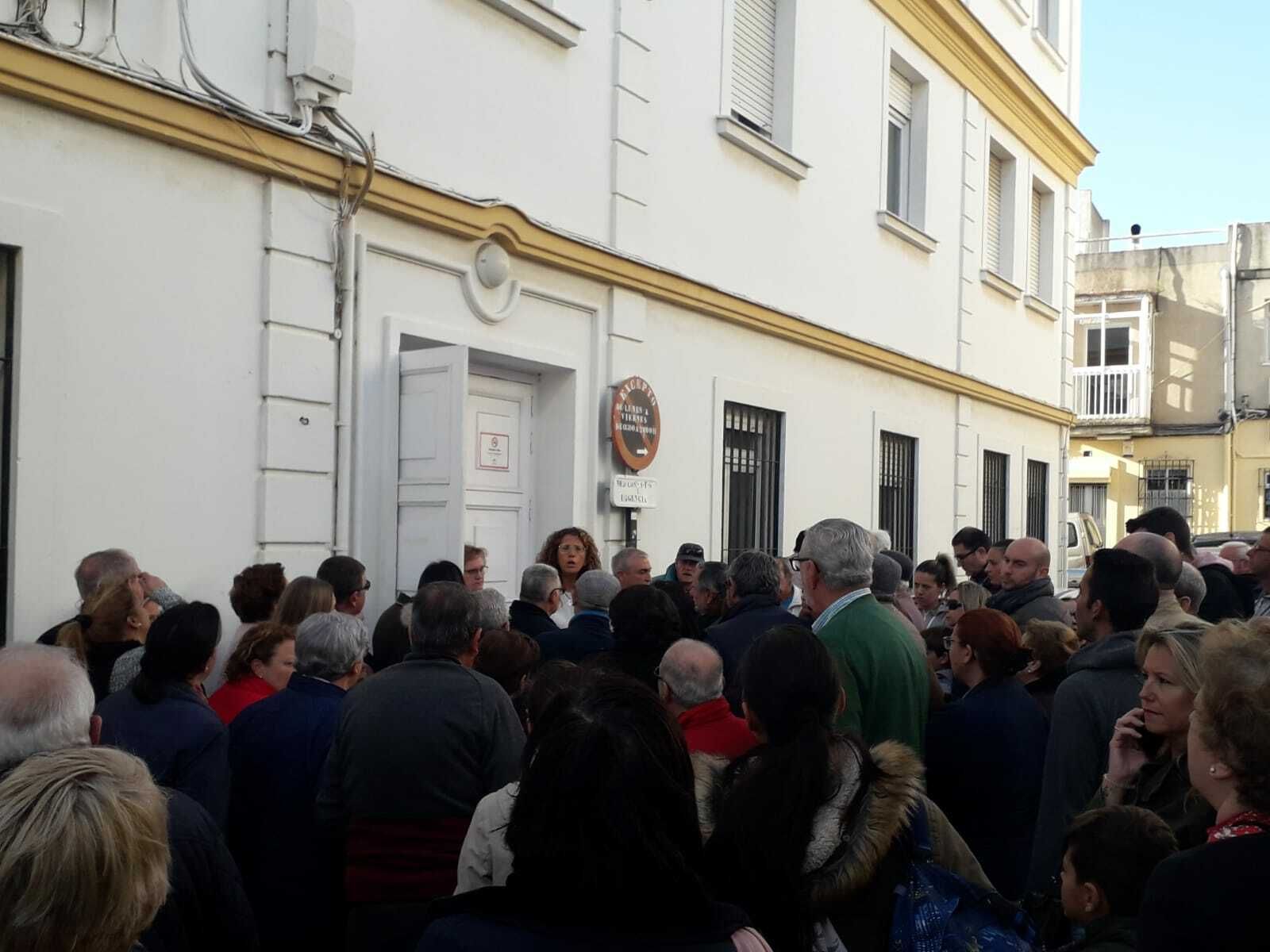 Usuarios agolpados a la puerta lateral del centro a la espera de explicaciones.