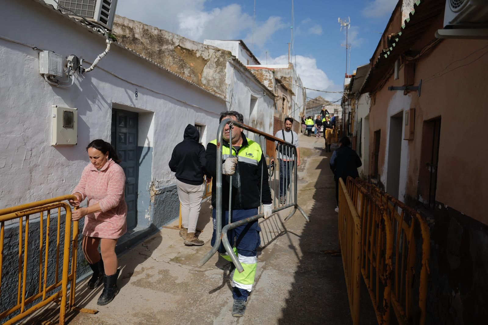 Los vecinos de Lora del Río se preparan para proteger sus casas de la crecida del Guadalquivir.