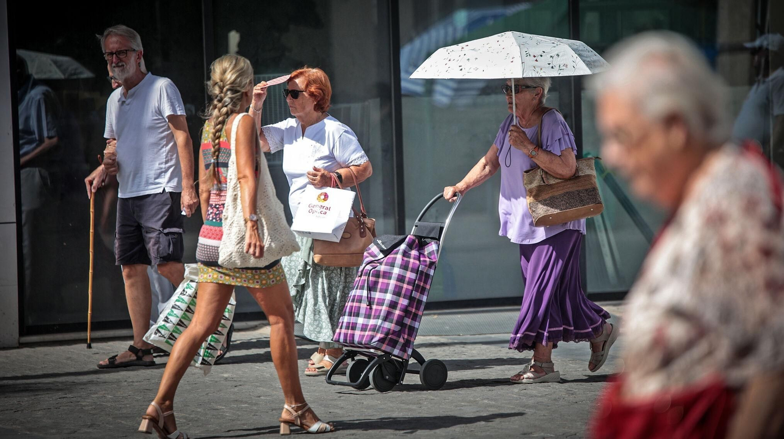 Varias personas caminando por una calle del centro de Jerez mientras apretaba el calor