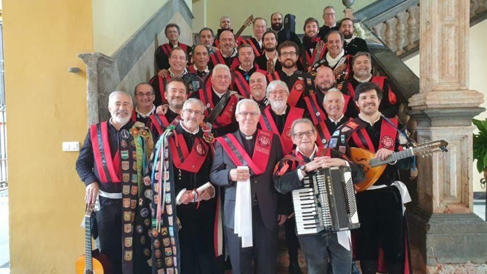 La Tuna de Peritos Industriales y el arzobispo, que bendijo el fajín blanco característico de su atuendo.