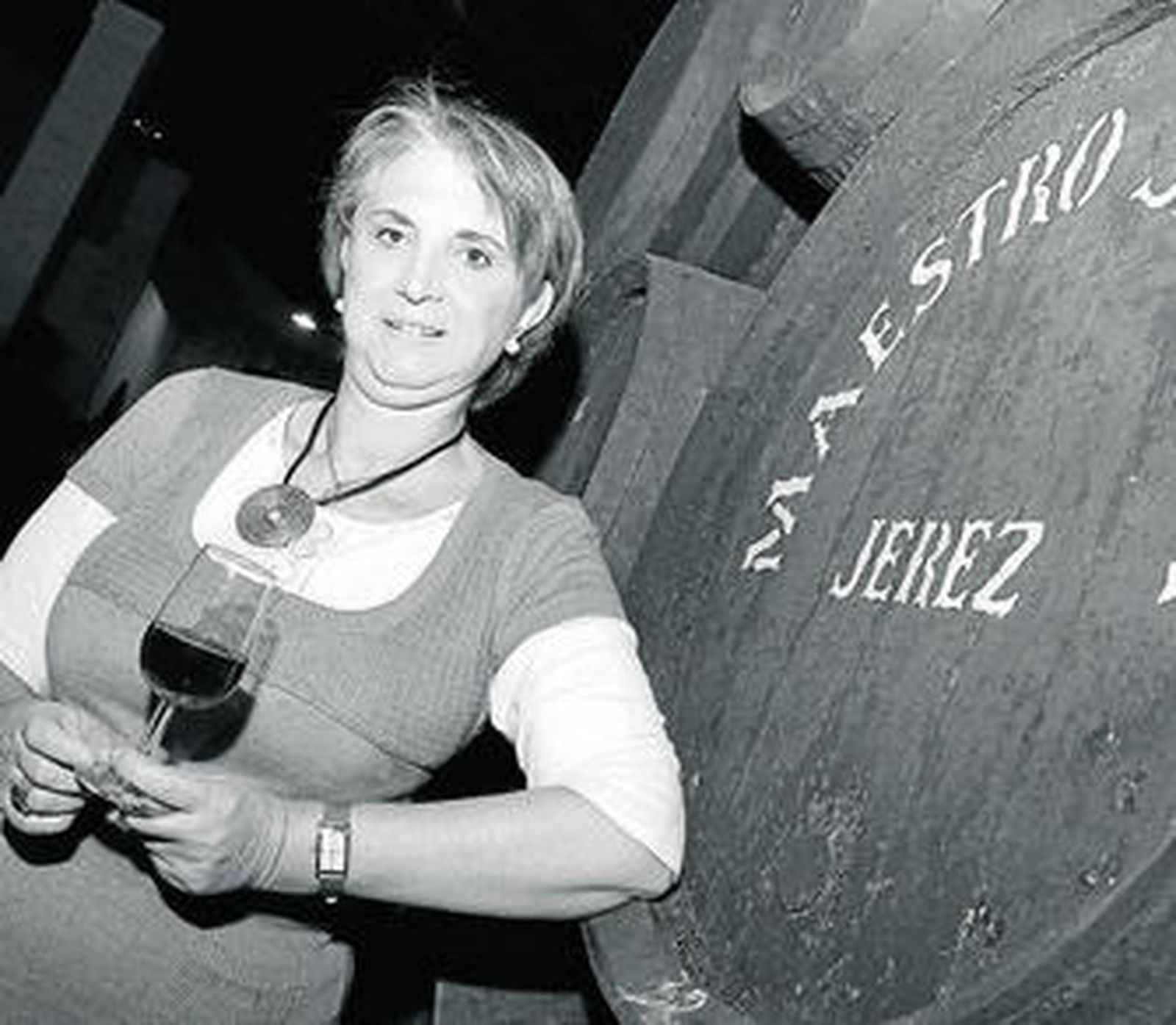 Carmen Borrego sostiene una copa de oloroso en una nave de las bodegas 'Maestro Sierra'.