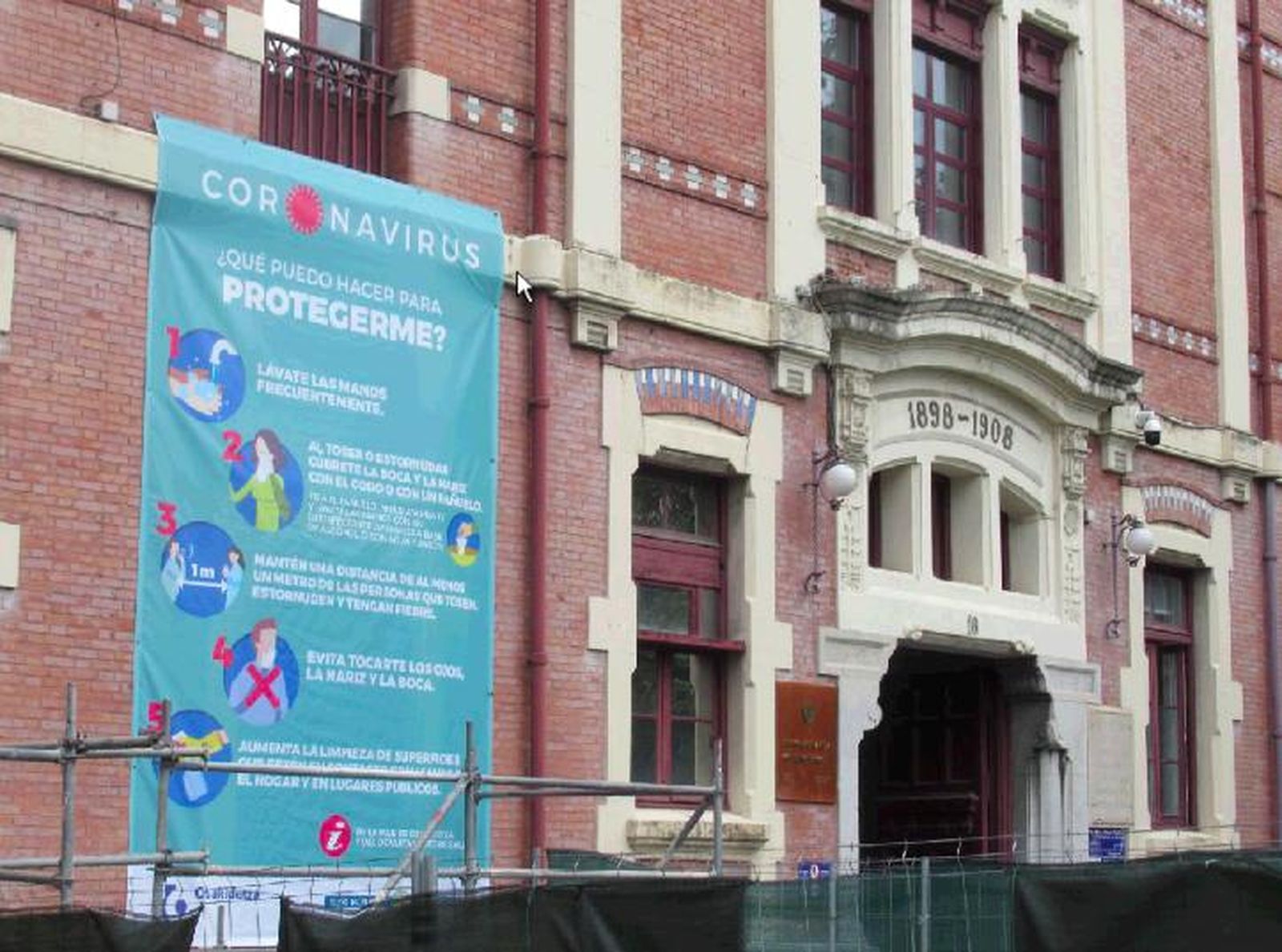 Un cartel sobre el coronavirus en la fachada del Hospital de Basurto.