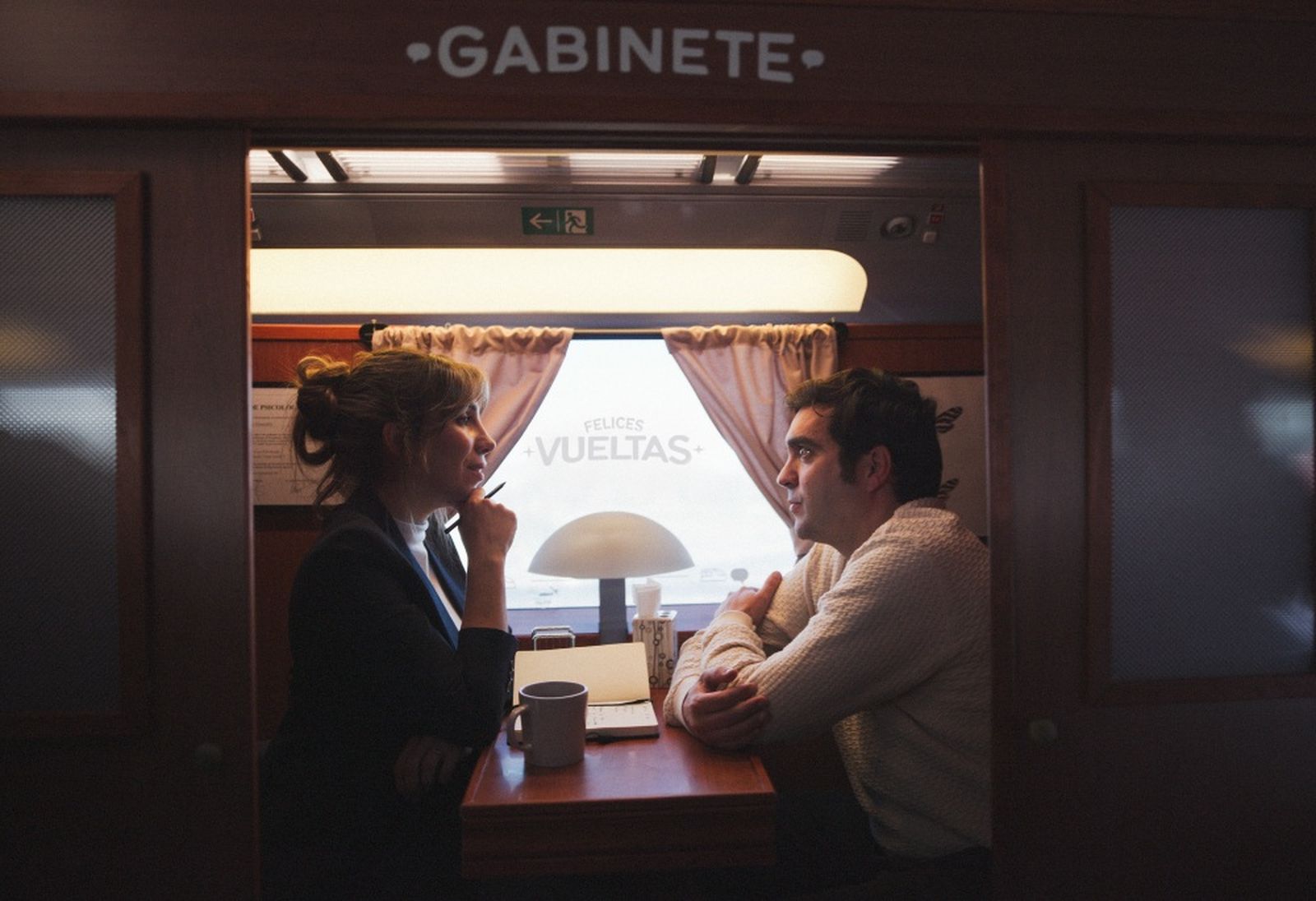 Dos viajeros comparten un viaje de regreso a bordo de un tren.