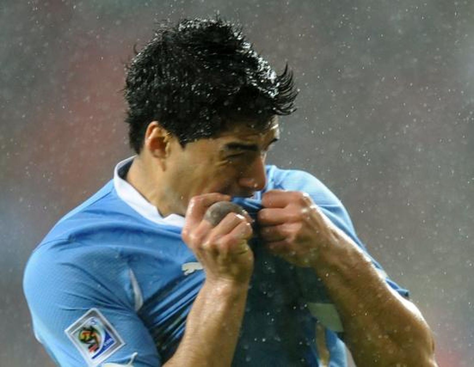 Luis Suárez se besa el escudo en el gol decisivo. / Reuters