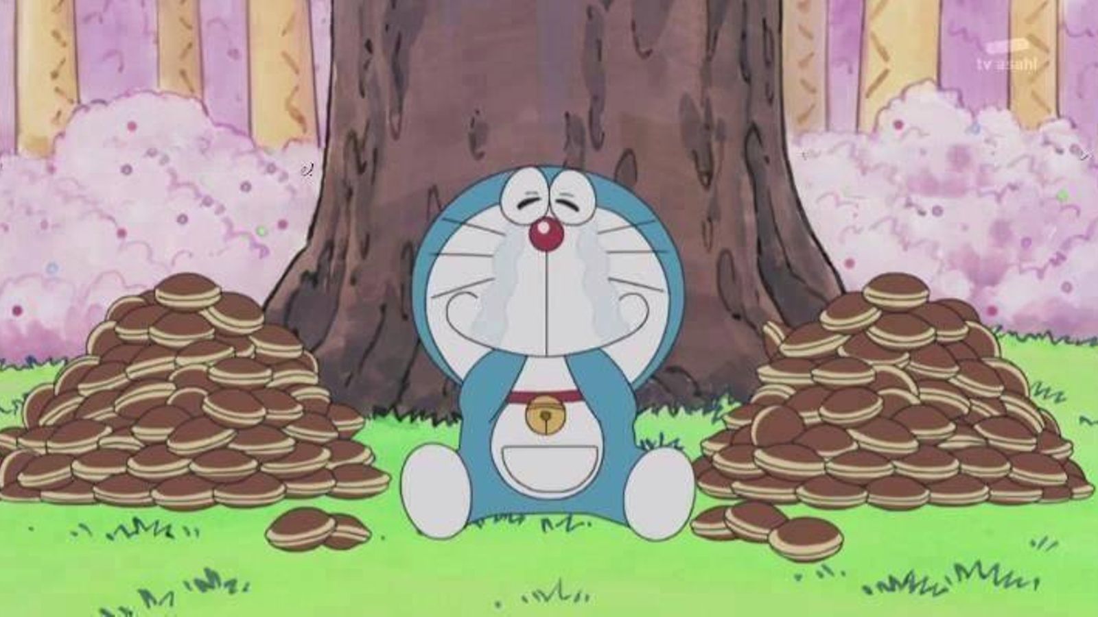 El gato cósmico con dos montañas de dorayakis que engulle llorando