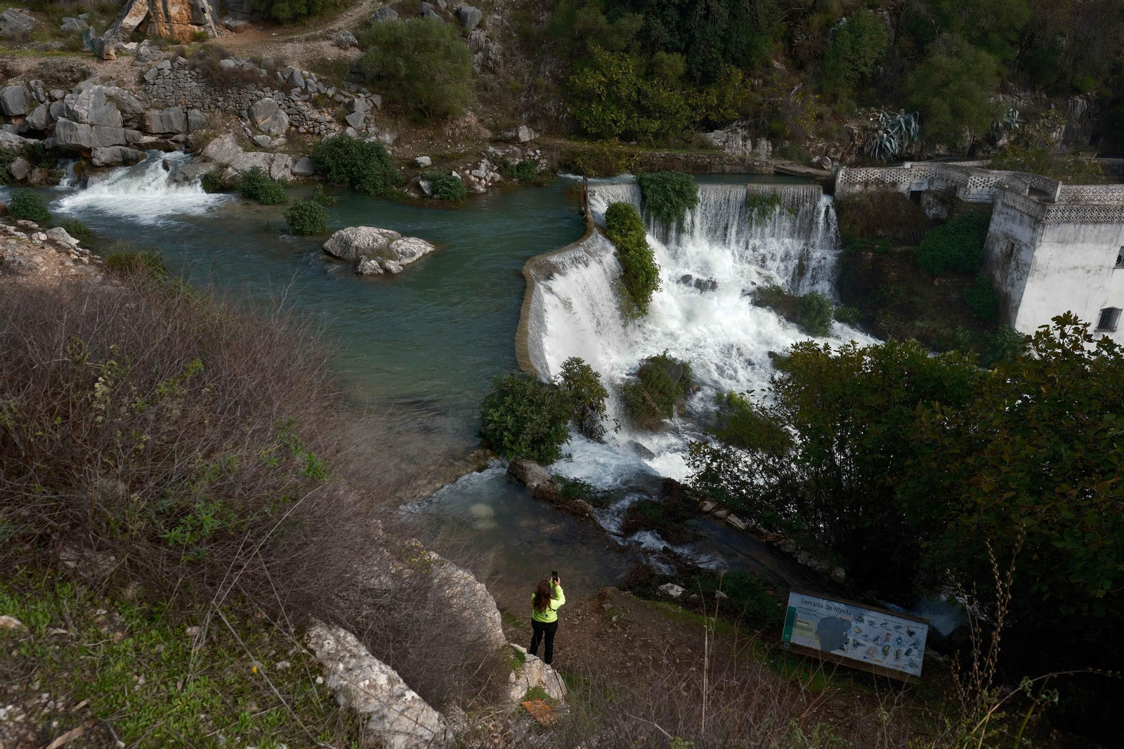 Una senderista observa el nacimiento de la Estación de Benaoján.