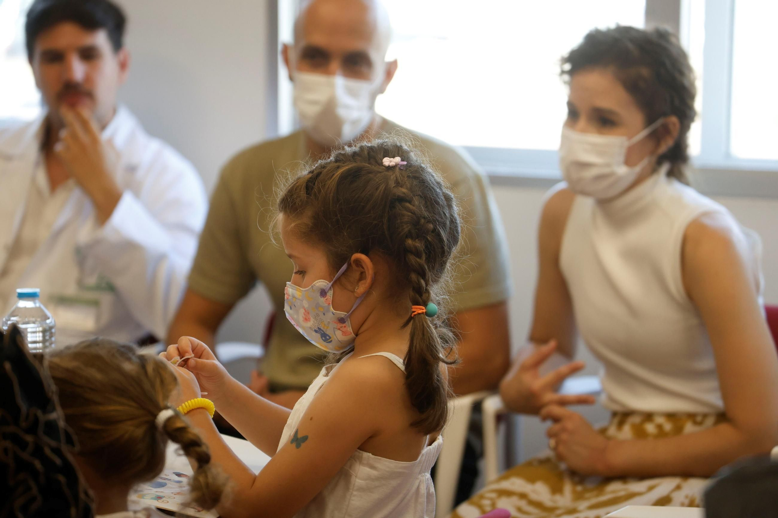 Lucía, la pequeña trasplantada, con sus padres detrás