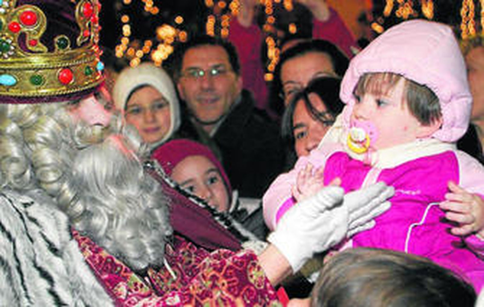 Una niña saluda al rey Melchor.