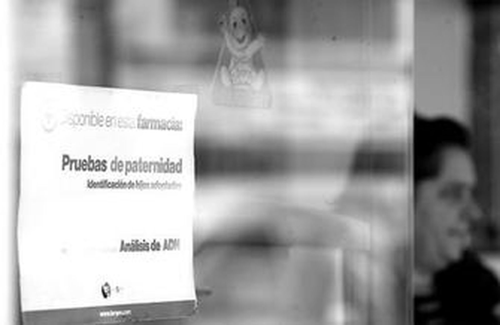Cartel en el que se anuncia el kit para la prueba de paternidad en la puerta de una farmacia de Carretera de Cádiz.