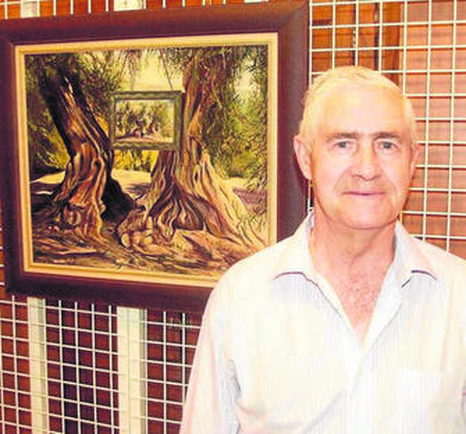 Jesús del Rey con uno de sus óleos sobre olivos en el Faro.