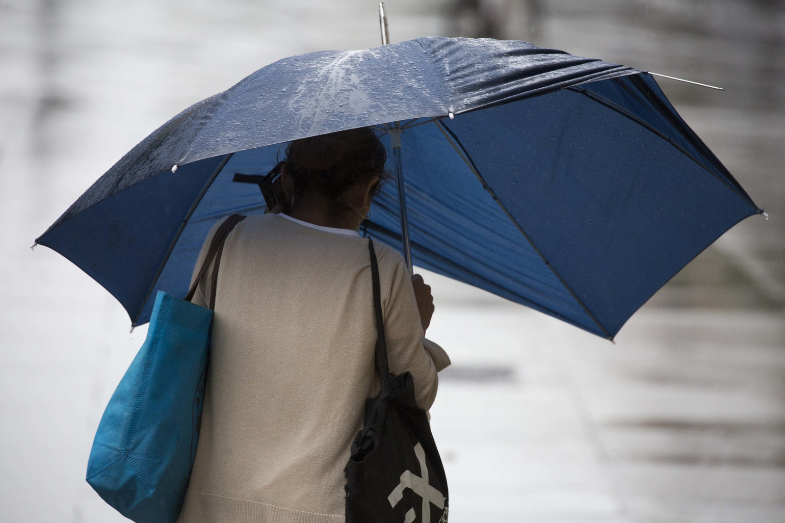 Una mujer se cubre con un paraguas un día de lluvia en Sevilla.