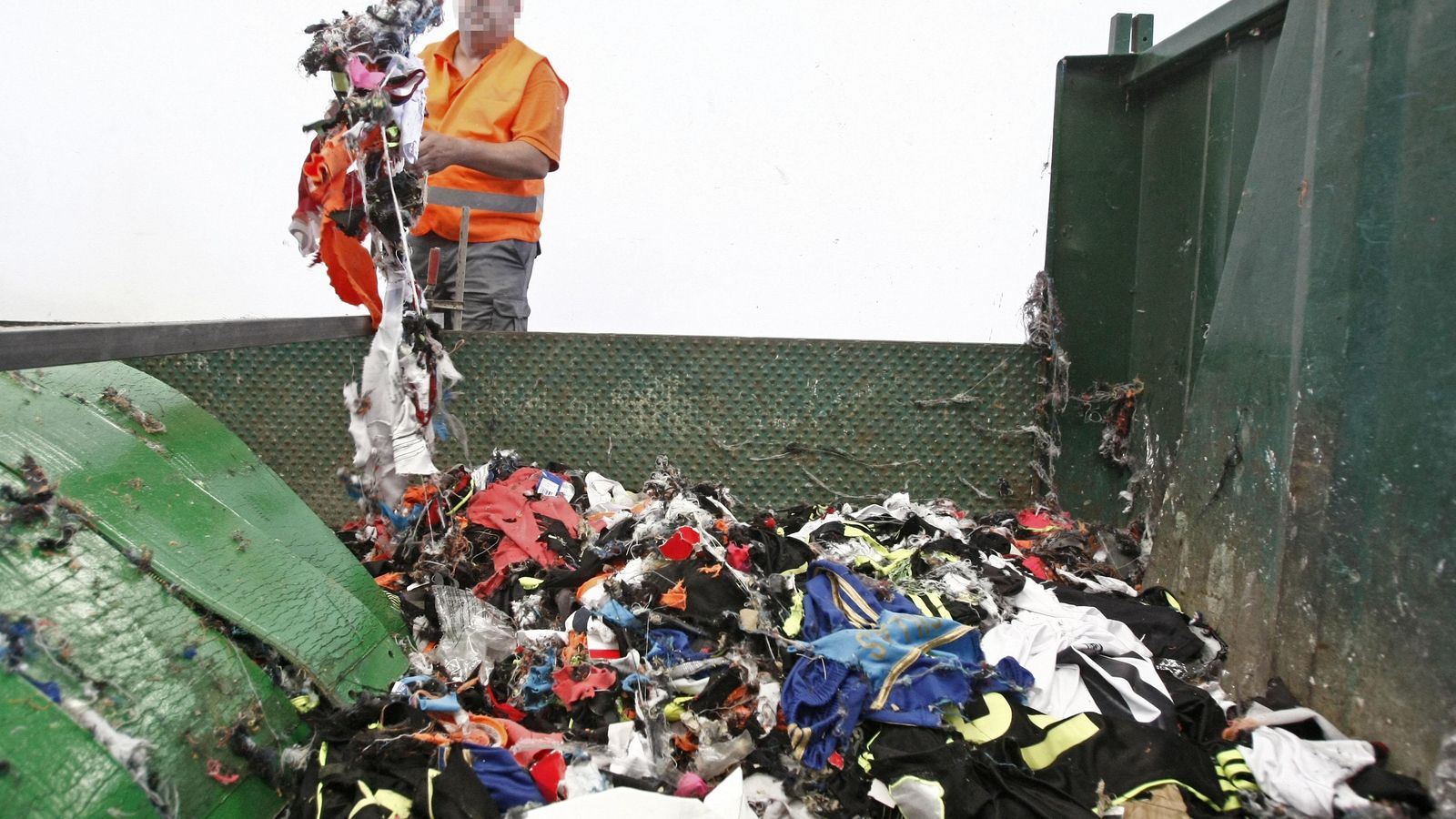 Un operario destruye mercancía falsificada intervenida en el Puerto de Algeciras.