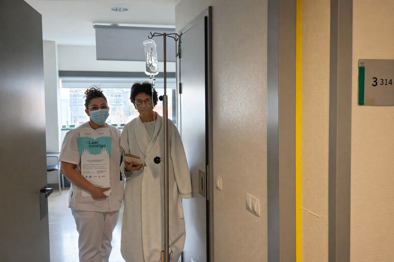 Una enfermera junto a una paciente del proyecto 'Leer Coontigo'