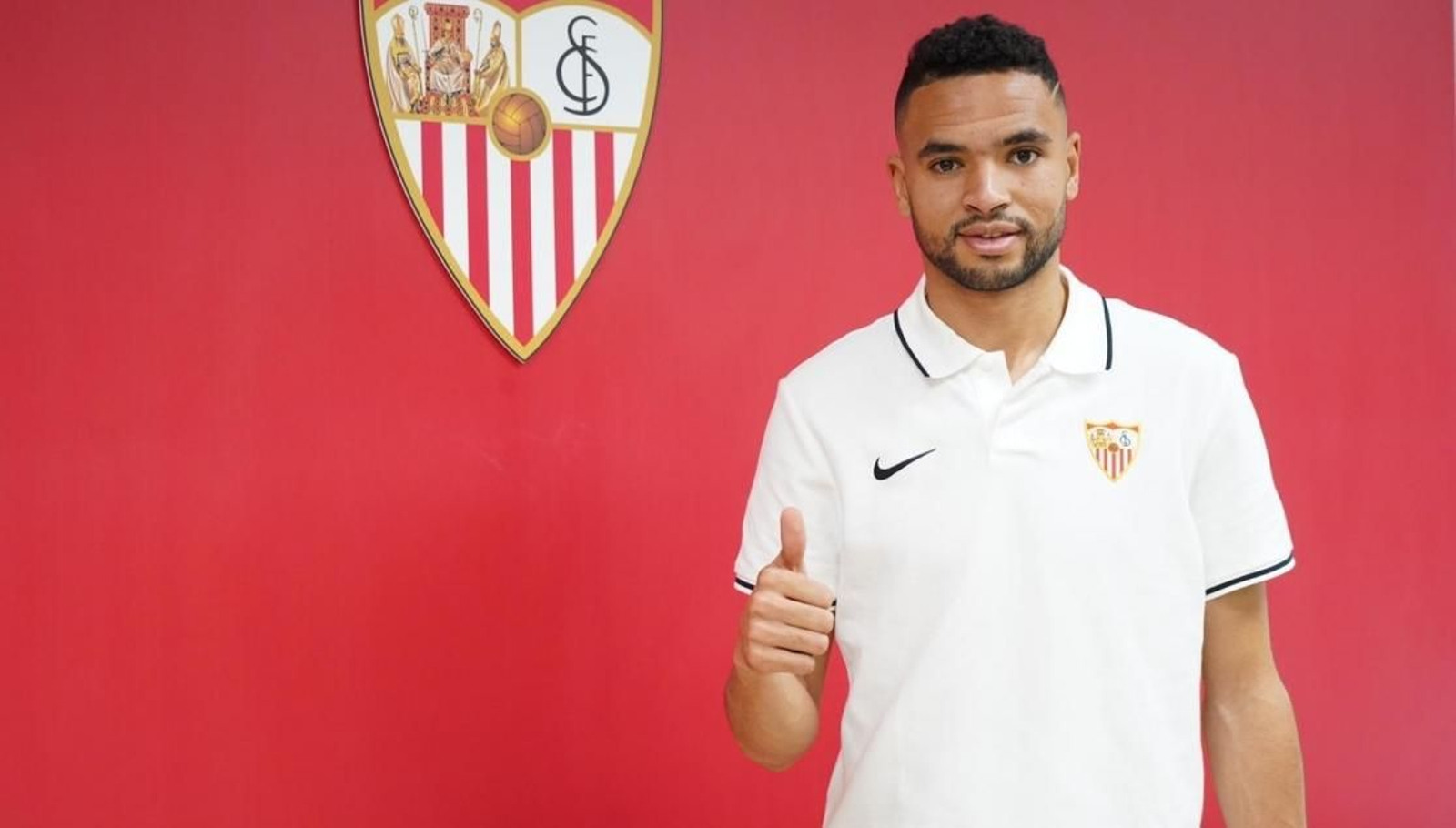 En-Nesyri posa con el escudo del Sevilla FC tras firmar su contrato.
