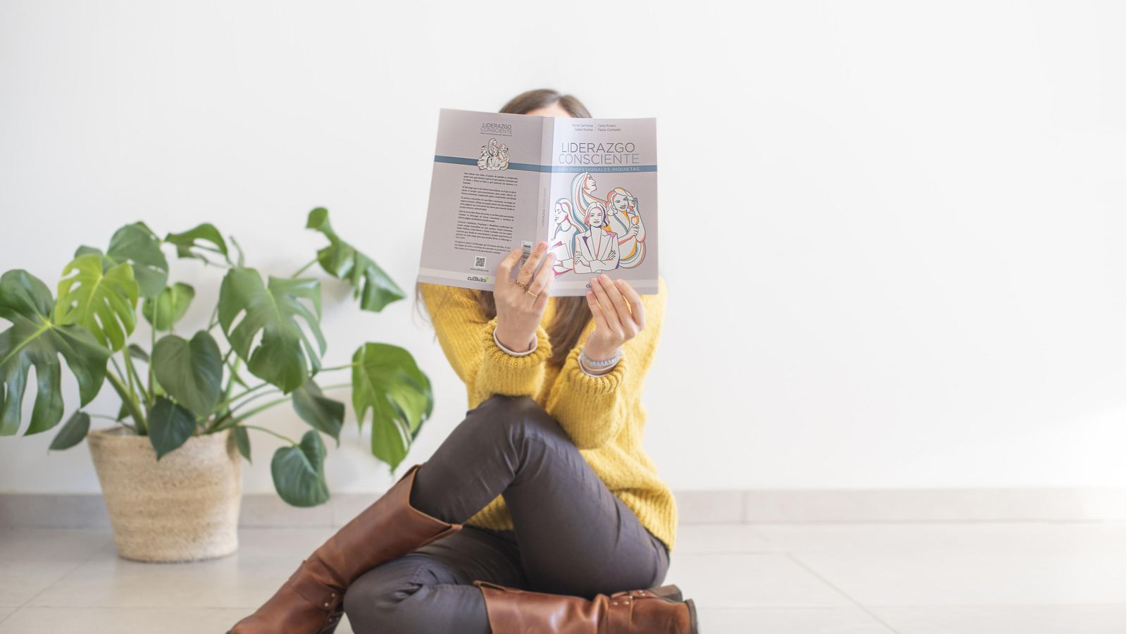 Una joven lee el libro 'Liderazgo consciente para profesionales inquietas'