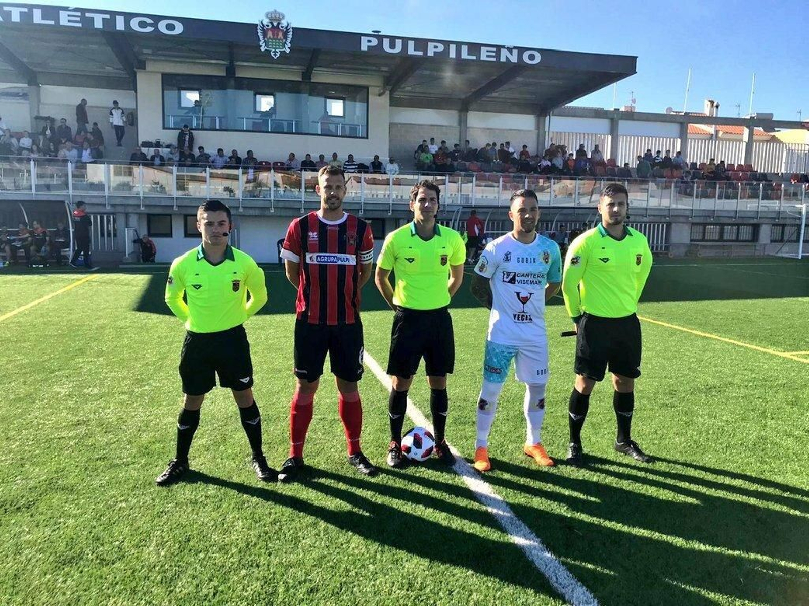 Los capitanes con el trío arbitral.