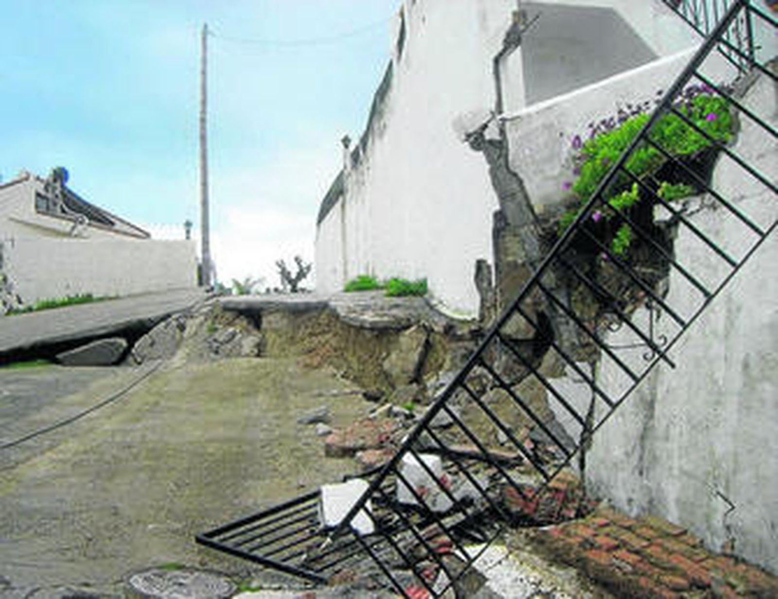 Una calzada hundida y destrozos en viviendas de Manilva.