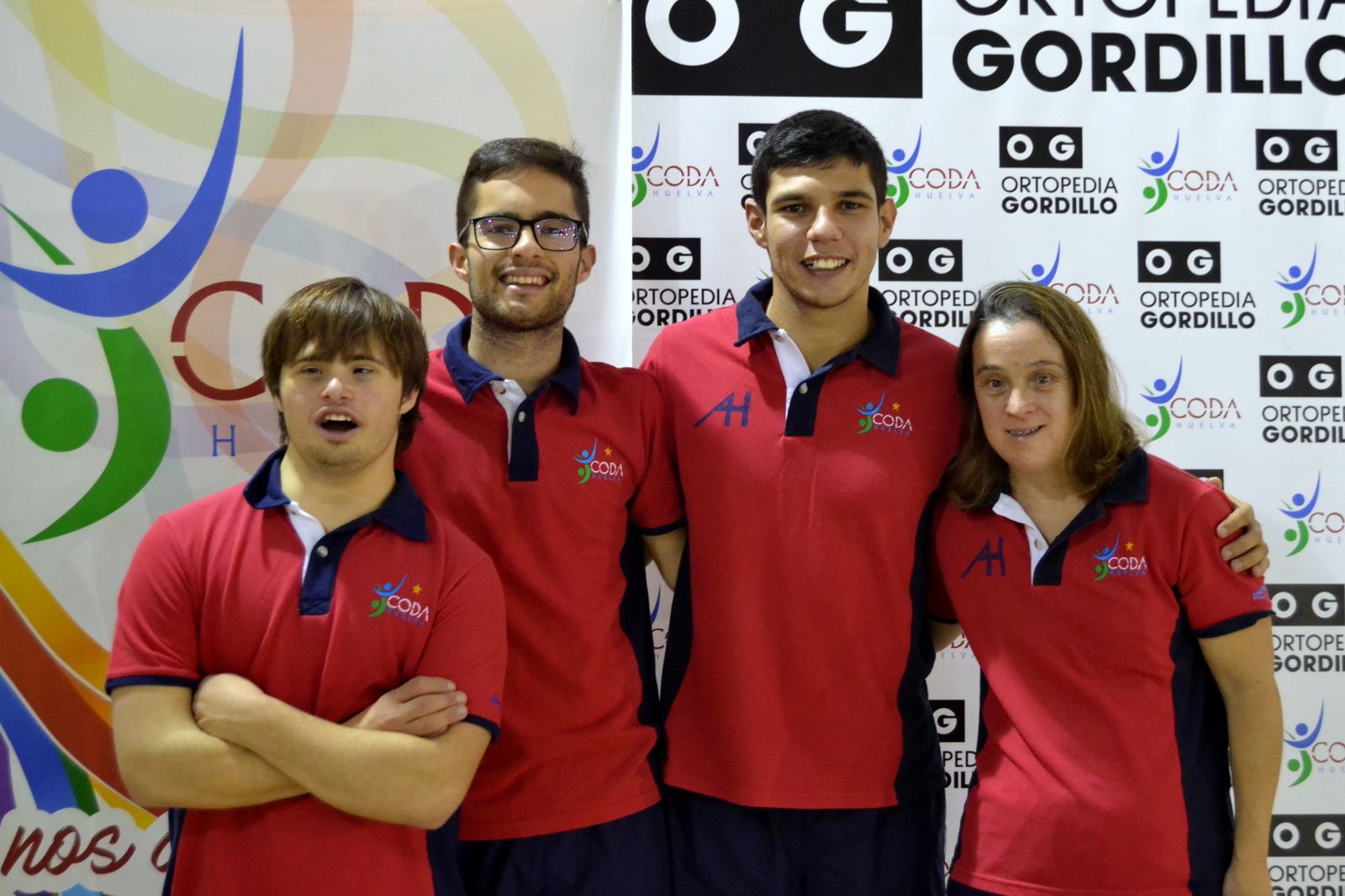 Los nadadores del CODA posan junto a un cartel de su patrocinador