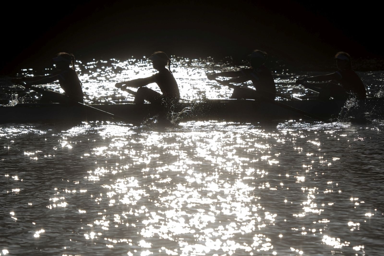 Varios deportistas practican remo.