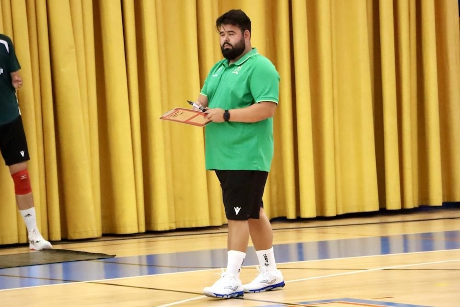 El entrenador del conjunto ahorrador sujeta su pizarra desde la banda durante un momento de la disputa de la Copa de Andalucía.