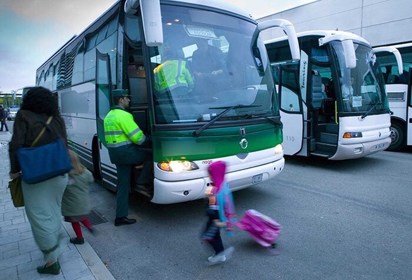 Agentes de la Guardia Civil inspeccionan un autobús que transporta niños al colegio.