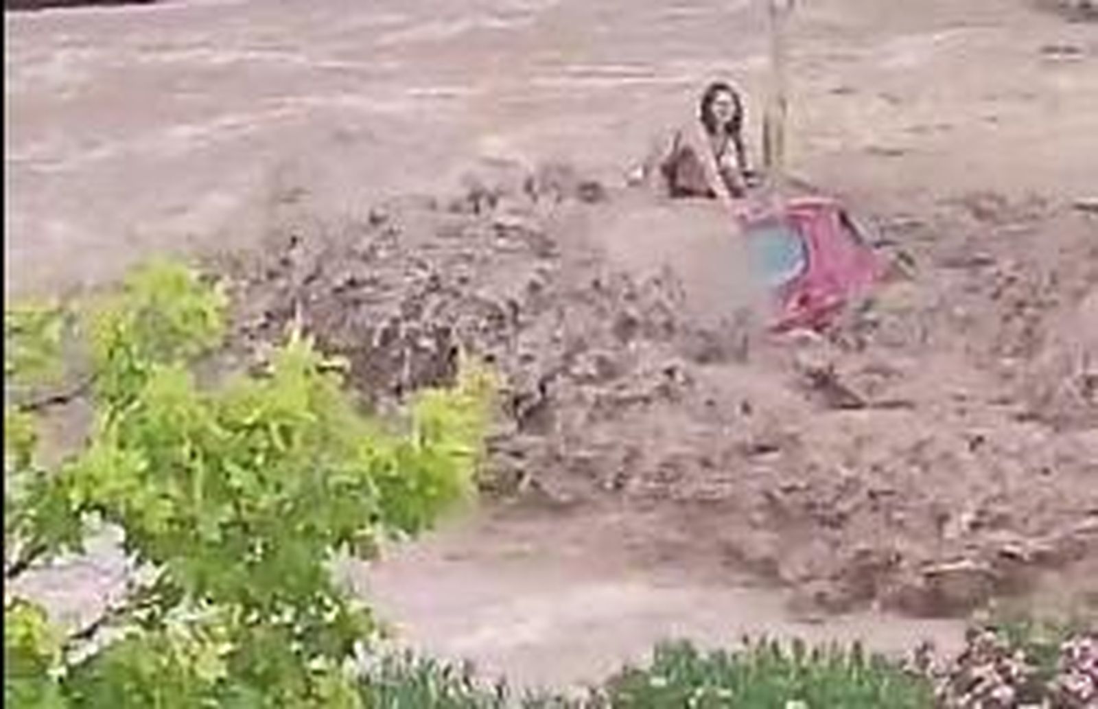 Una mujer aguanta subida en su coche a que los bomberos la rescaten