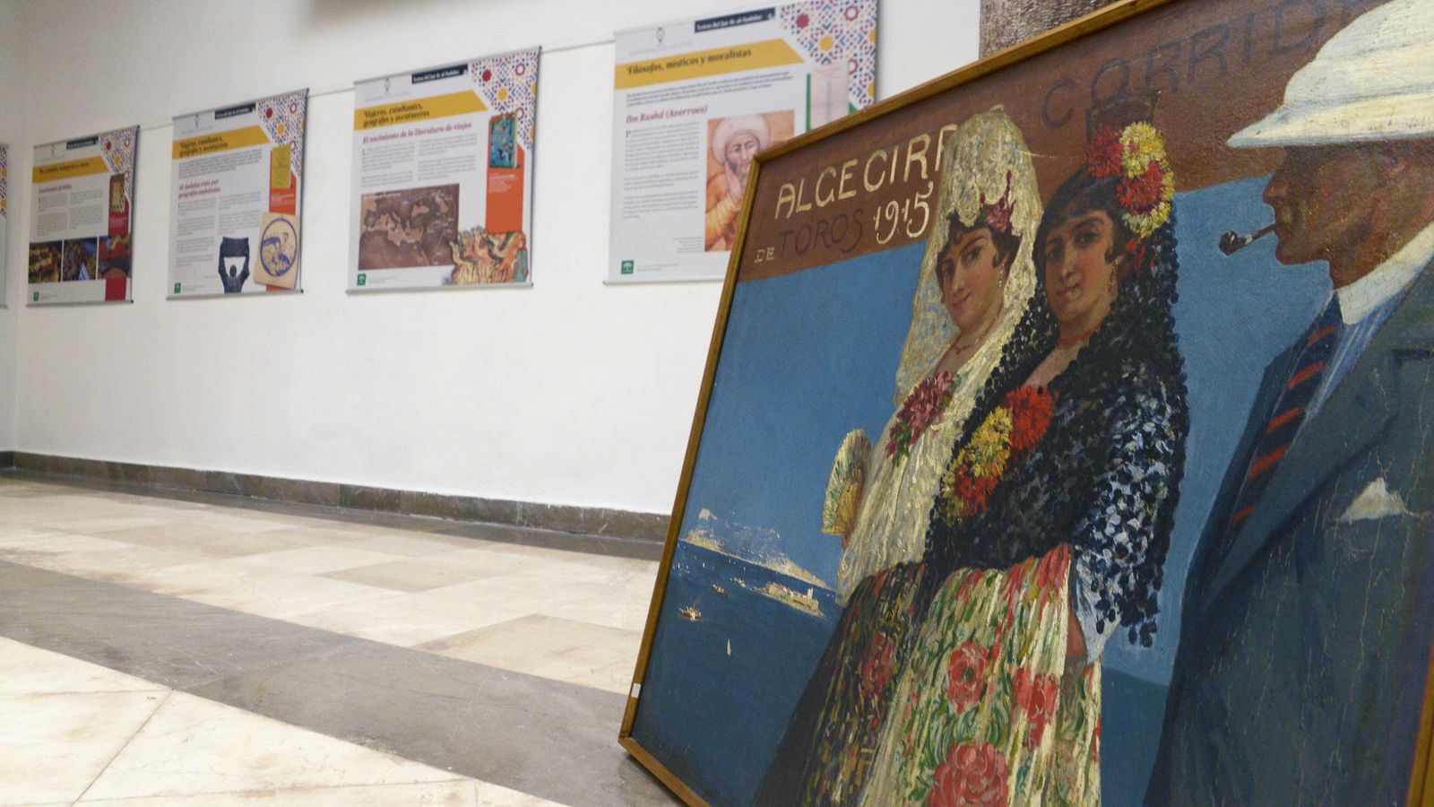 Cartel de la Feria taurina de Algeciras 1915 Óleo sobre lienzo de Mariano Bertuchi con escena de dos mujeres ataviadas con trajes de fiesta de principios de siglo y un hombre. Cartel de la Feria taurina de Algeciras 1915 Óleo sobre lienzo de Mariano Bertuchi con escena de dos mujeres ataviadas con trajes de fiesta de principios de siglo y un hombre.