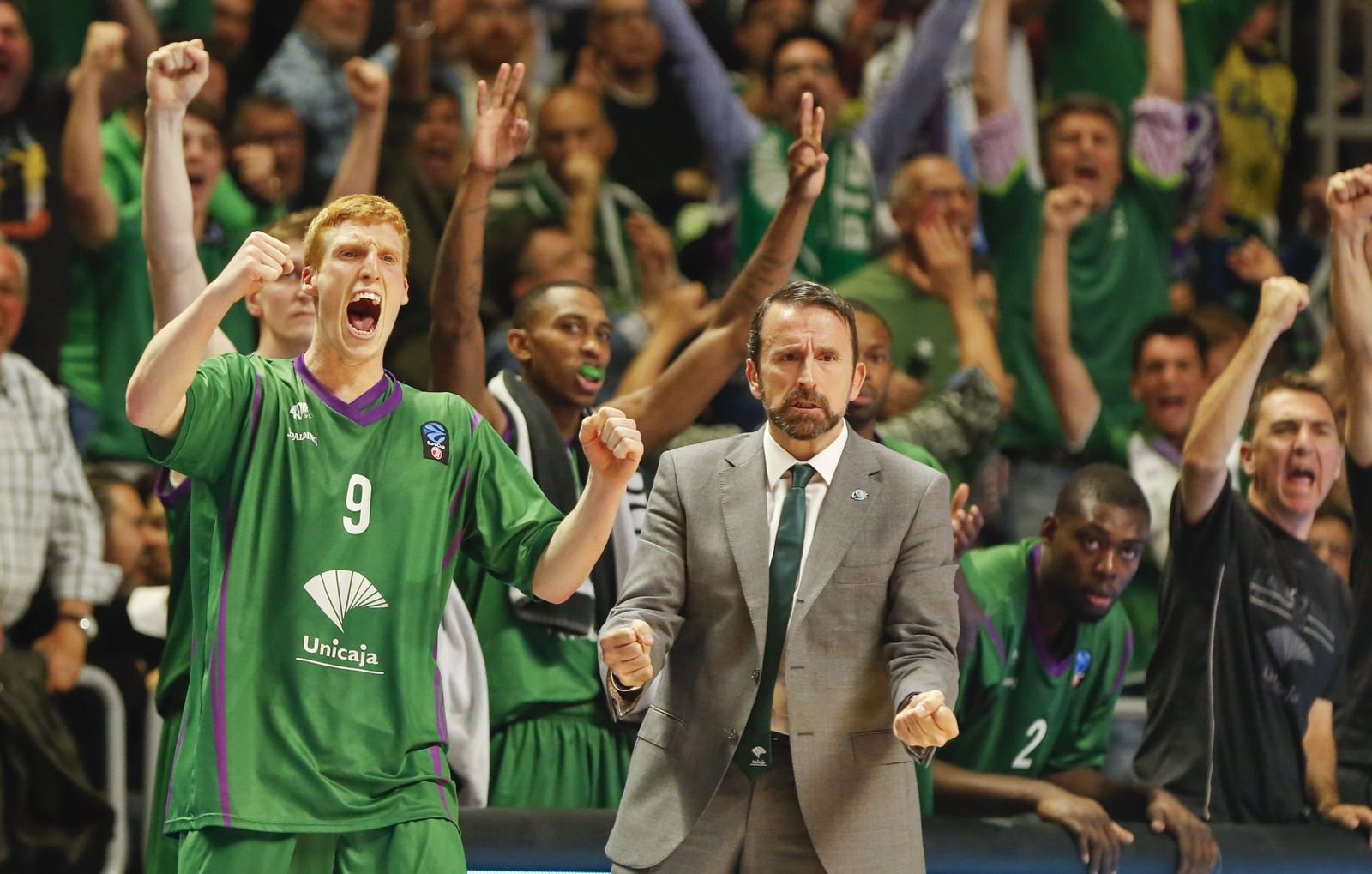 El banquillo del Unicaja, con Alberto Díaz y Joan Plaza en primer plano, celebran una canasta ante el Lokomotiv Kuban.