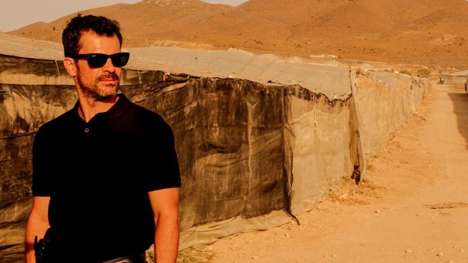 Rodolfo Sancho (Héctor), el protagonista, con los 'plásticos' de fondo de la localidad ficticia de Campoamargo, en Almería.