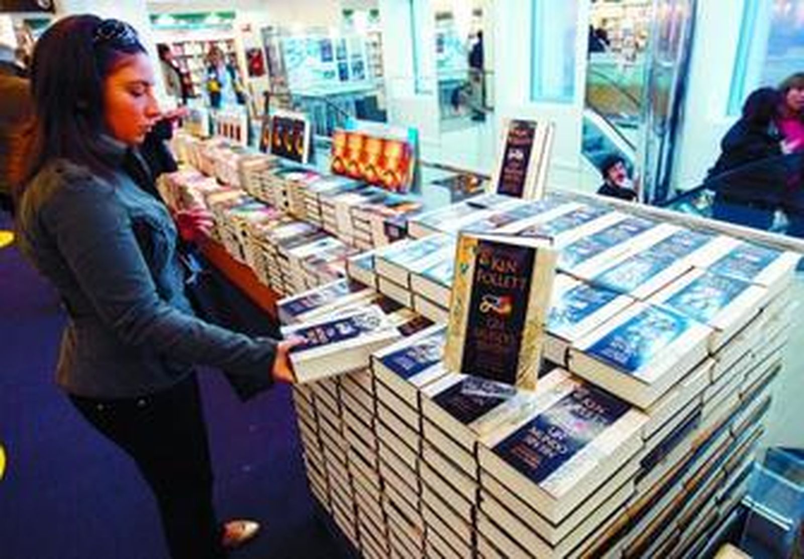 Una joven observa un ejemplar de 'Un mundo sin fin', continuación de 'Los pilares de la Tierra'.