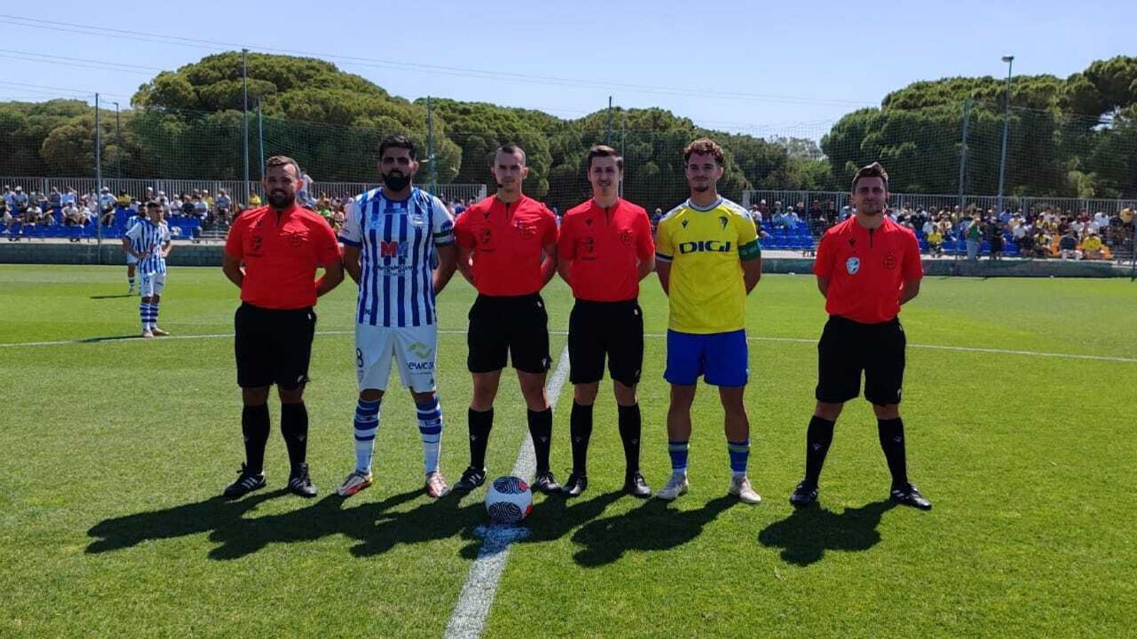 El colegiado Carlos Mejías Galán, junto a los capitanes Kevin y Román.