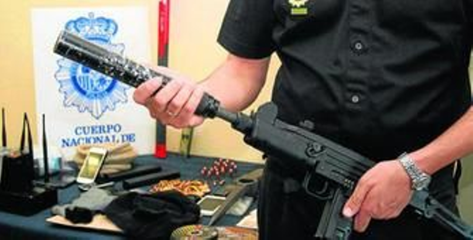 Un agente muestra un subfusil UZI, fabricado en Croacia, que fue intervenido a la organización desarticulada por la Policía Nacional.