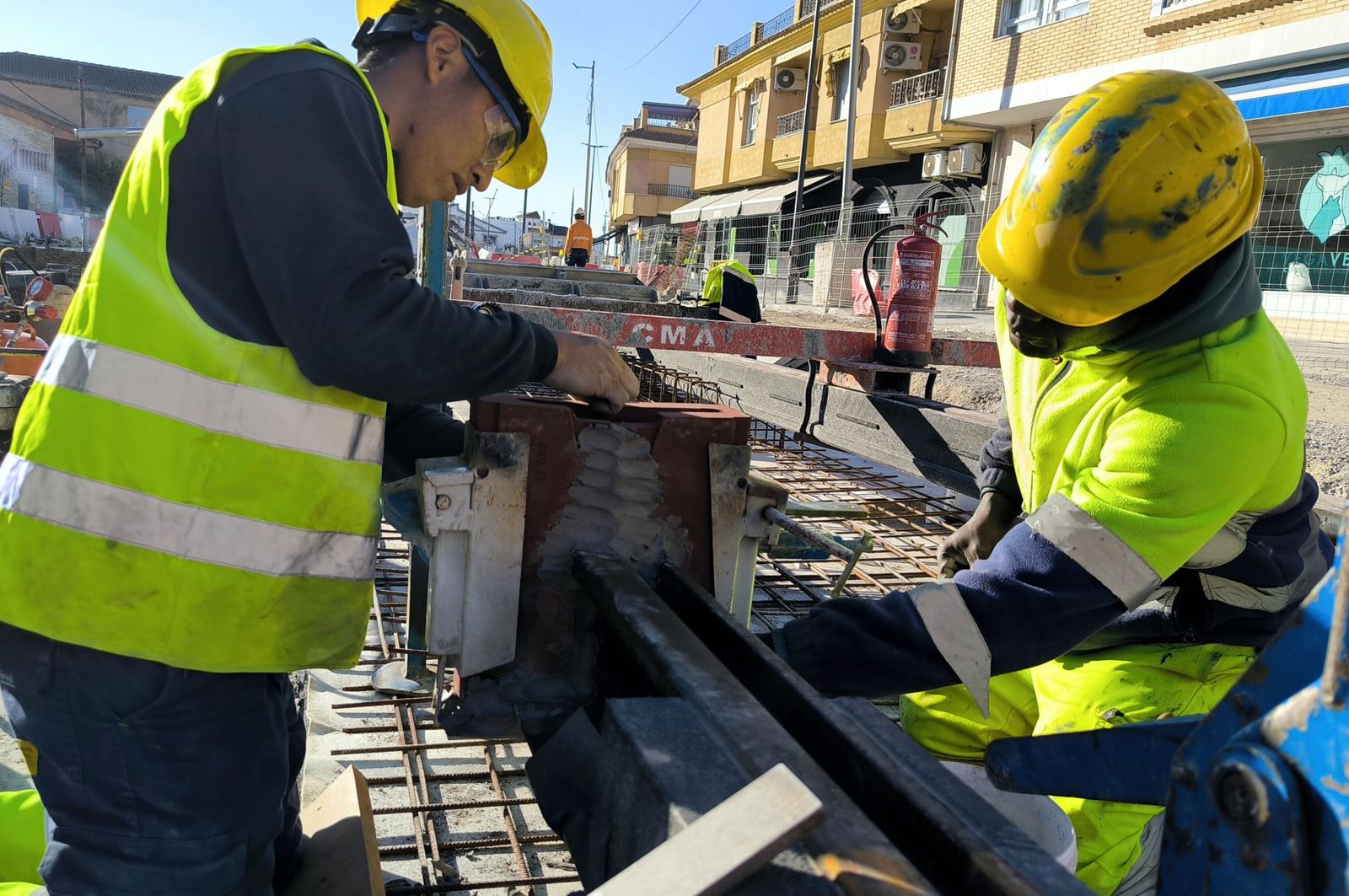 Dos operarios del Metro ejecutan una de las últimas soldaduras en Churriana de la Vega