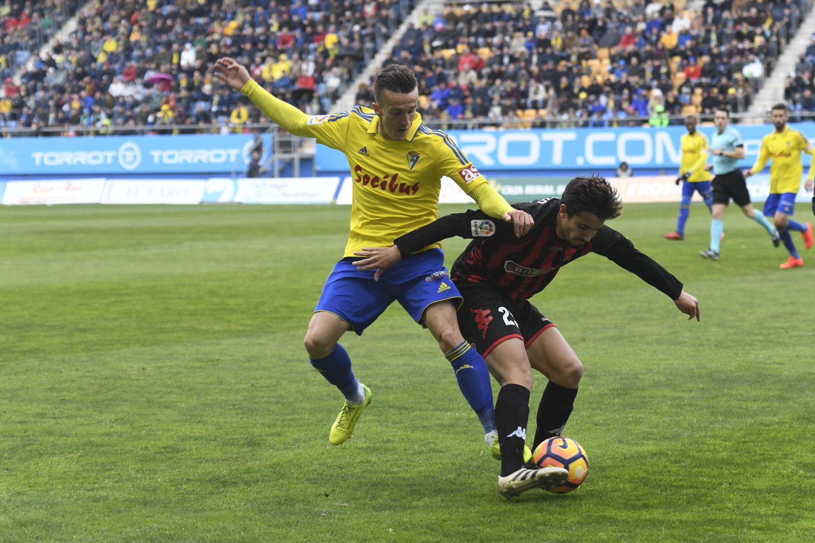 Raphael Guzzo, jugador del Reus, protege el esférico ante la presión de Salvi (Cádiz).