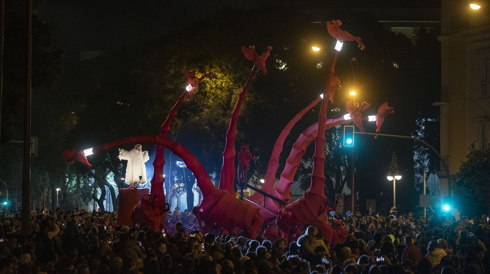 Las imágenes del pasacalles con marionetas gigantes de jirafas, por el Paseo de Colón
