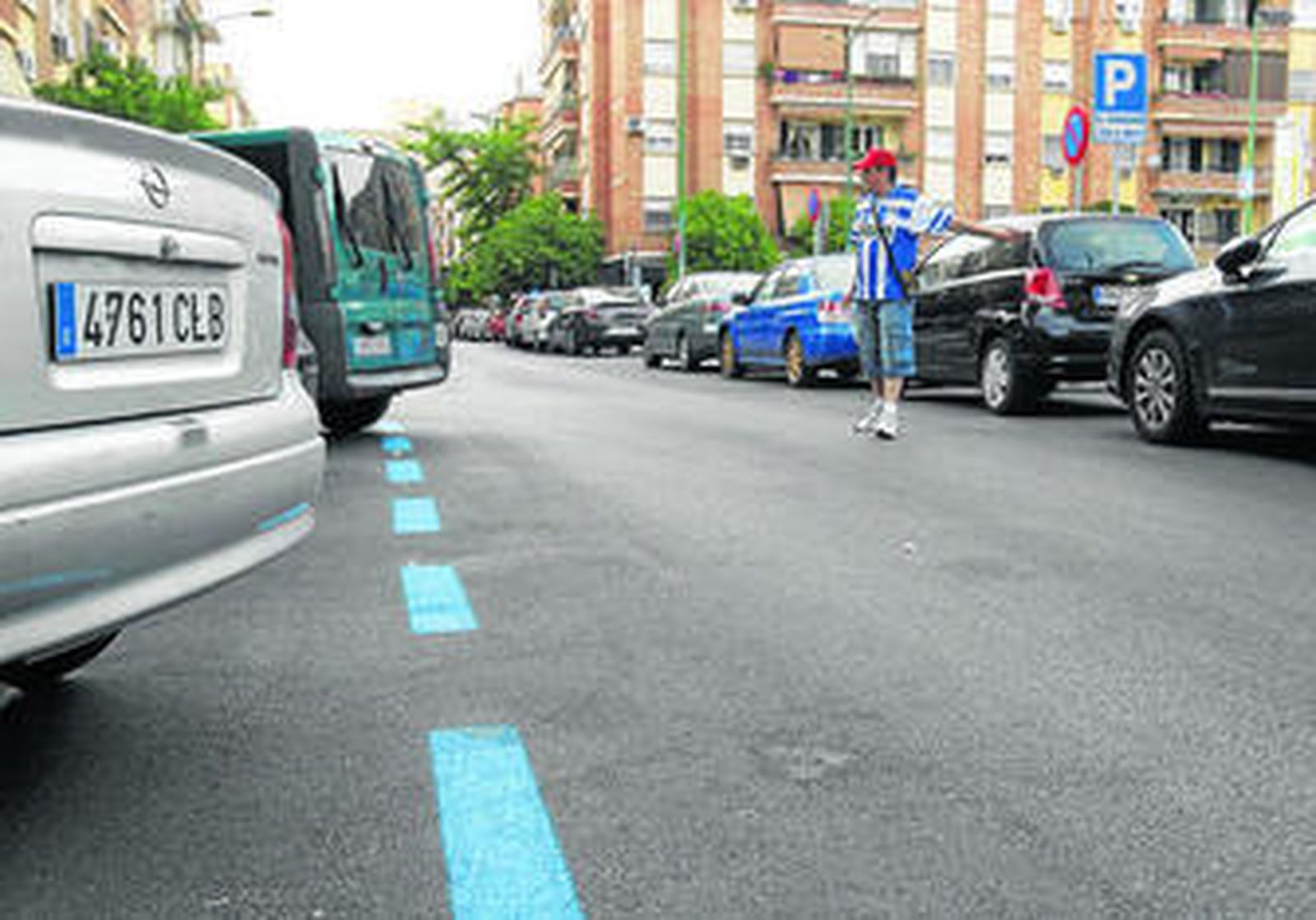 Un 'gorrilla' ayuda a aparcar en la Plaza de Rafael Salgado, en la que ya está pintada la zona azul que entrará en funcionamiento la próxima semana.