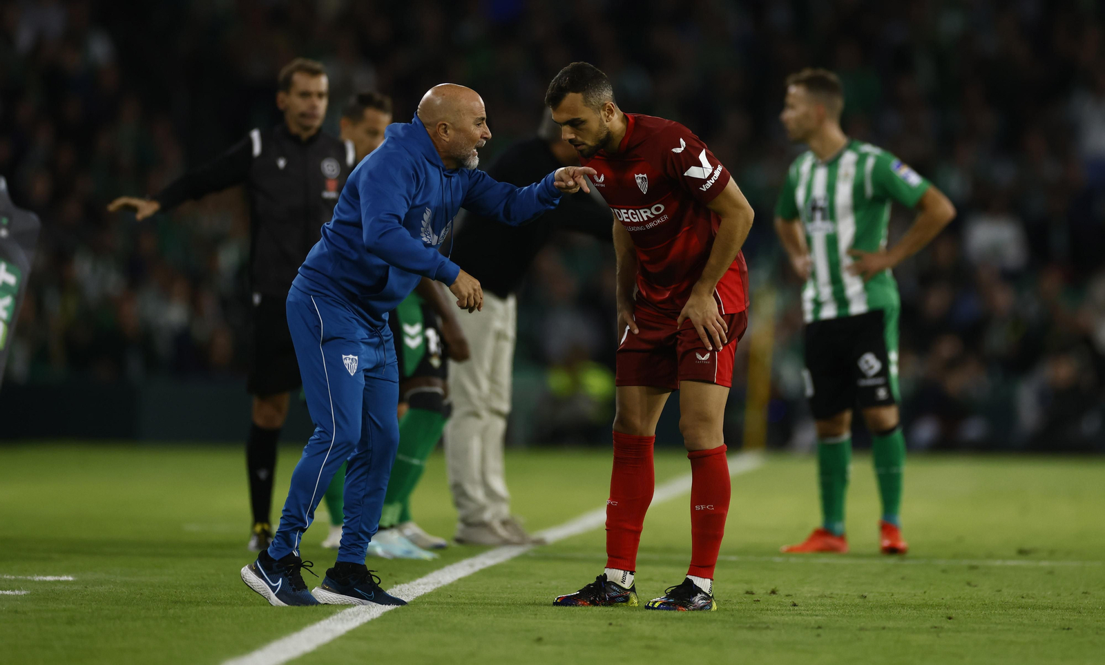 Sampaoli le da instrucciones a joan Jordán mientras hace lo propio Pellegrini con Canales.
