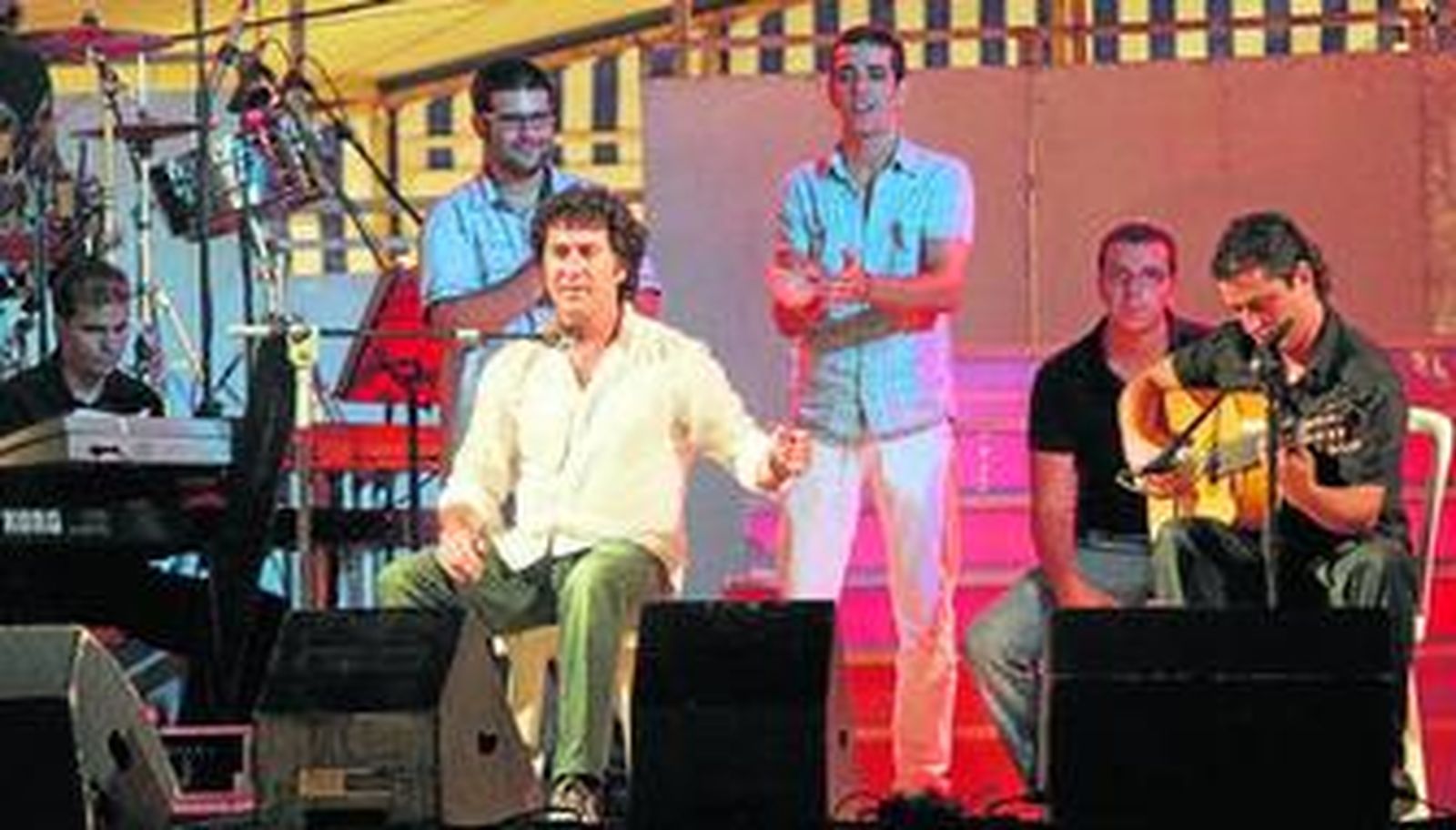 Julián Estrada interpreta una de sus canciones acompañado por un guitarrista en el Espacio Fiesta.