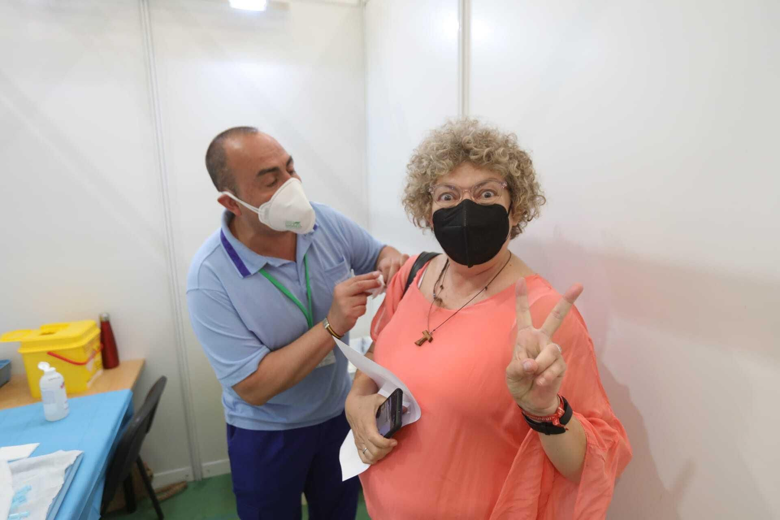 Una mujer hace el signo de la victoria tras ser inoculada este martes con la vacuna de Pfizer en el polideportivo Vega Veguita.
