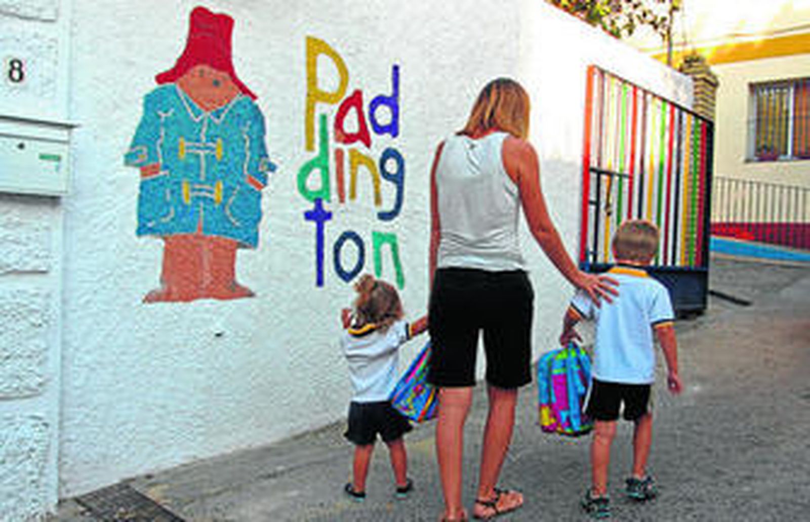 Una madre lleva a sus hijos a una guardería homologada por la Consejería de Educación.