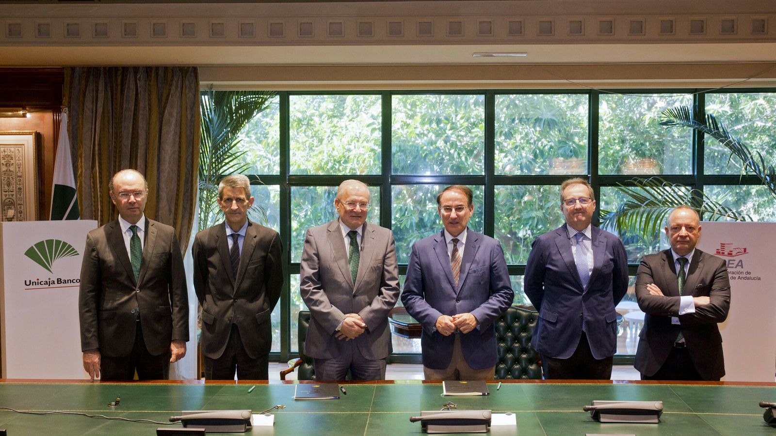 Responsables de Unicaja Banco y de la CEA tras la firma del convenio.