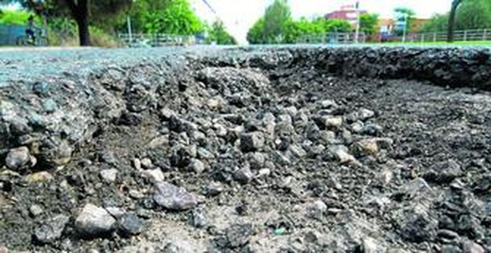 Agujeros de gran tamaño se suceden por la avenida Alcalde Luis Uruñuela, en Sevilla Este.