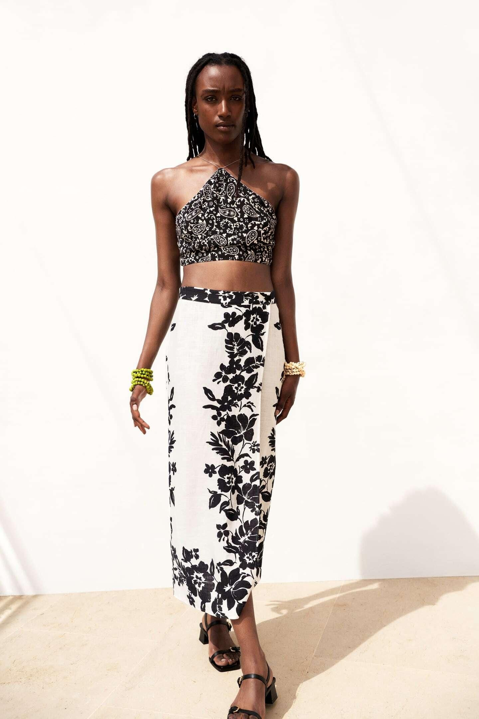 Falda pareo con estampado de flores negras de Zara.