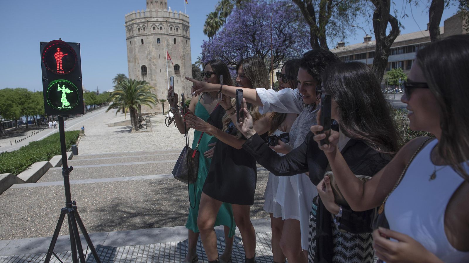 Jóvenes fotografían el semáforo de Macarena y Paco.