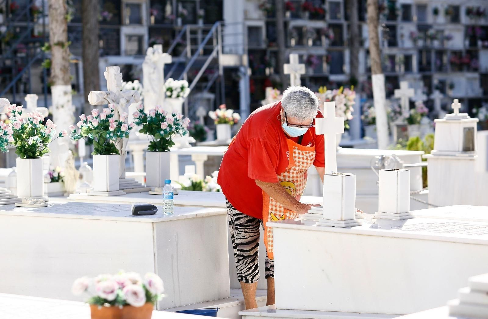 Una mujer con mascarilla en el cementerio de Málaga