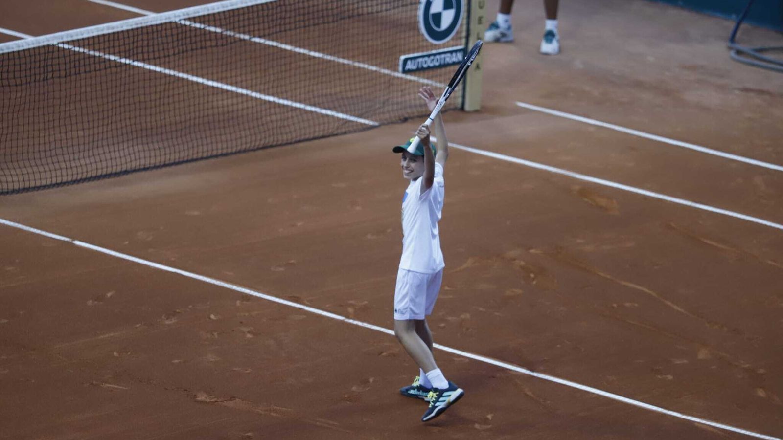 El joven recogepelotas celebra el punto ganado con la raqueta de Jil Teichmann.