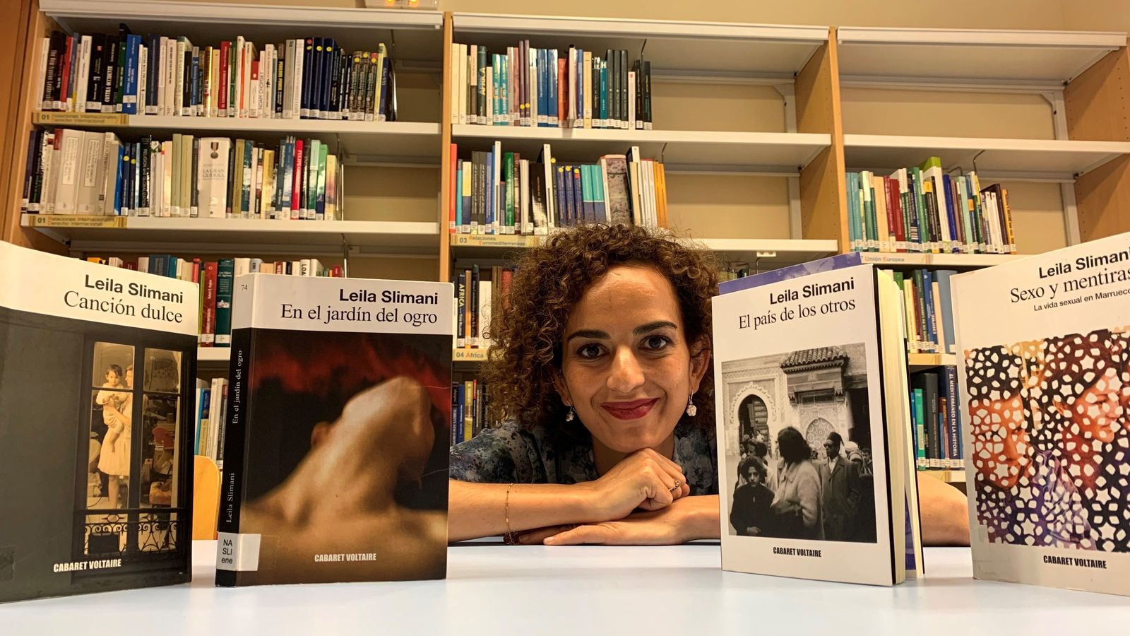 La escritora francomarroquí, junto a las ediciones de sus cuatro libros publicados en España.