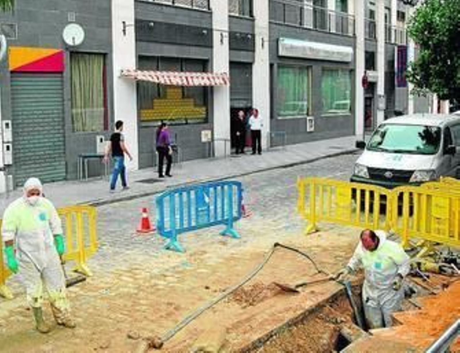 Varios operarios de Aguas de Huelva reparan la avería.