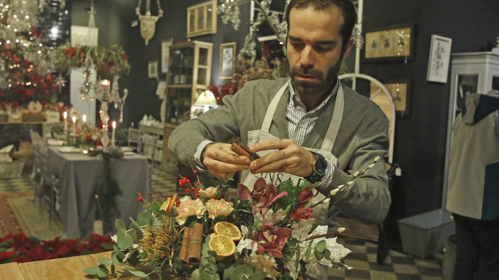 Rafa Cuevas prepara ramilletes de canela en rama para un centro de flores.